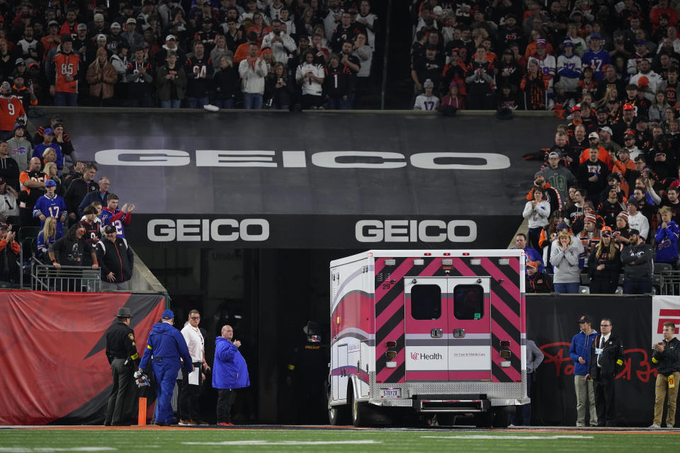 Fans look on as the ambulance leaves carrying Damar Hamlin of the Buffalo Bills after he collapsed on Jan. 2 in Cincinnati.
