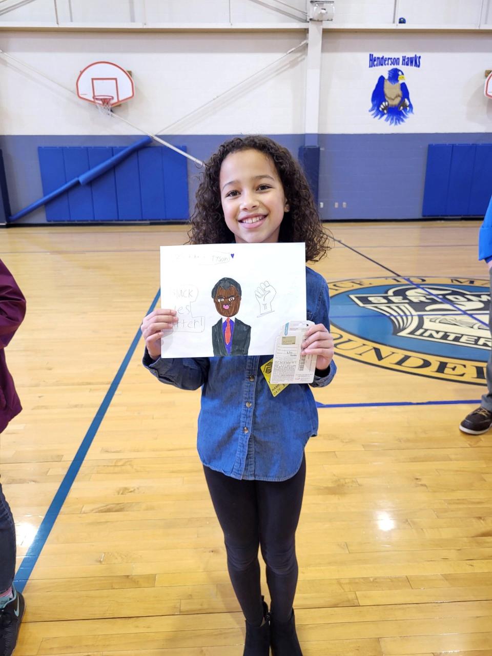 Boys & Girls Club of Springfield member Ayonna Cheek poses for a photo with her pencil and marker drawing of Neil deGrasse Tyson. Cheek won first place in the sixth annual Boys and Girls Club of Springfield and UScellular Black History Month Art Contest. She received $250 for her first place drawing.