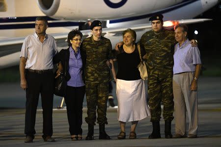 Angelos Mitretodis (L) and Dimitris Kouklatzis, two Greek soldiers who were detained in Turkey after crossing the border, are welcomed by their parents after being released, at the airport of Thessaloniki, Greece, August 15, 2018. REUTERS/Alexandros Avramidis