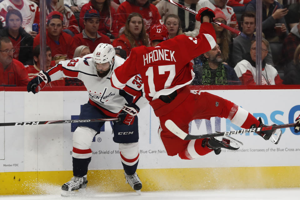 Washington Capitals defenseman Radko Gudas (33) checks Detroit Red Wings defenseman Filip Hronek (17) during the second period of an NHL hockey game Saturday, Nov. 30, 2019, in Detroit. (AP Photo/Carlos Osorio)