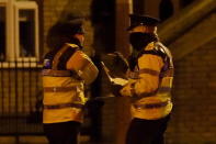 Police officers attend to the scene of a shooting at Poplar Row in Dublin, Ireland February 8, 2016. REUTERS/Clodagh Kilcoyne