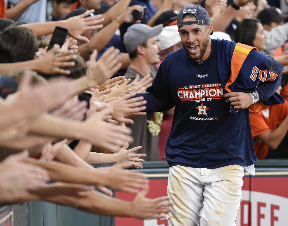 FILE - Houston Astros' George Springer celebrates with fans after the team's win over the Seattle Mariners and clinching of the AL West crown in a baseball game in Houston, in this Sunday, Sept. 17, 2017, file photo. It's a sad time for Houston sports fans after multiple superstars have left he city in the last year. (AP Photo/Eric Christian Smith, File)