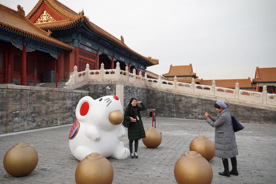 Chinese tourists flock to take photos with a newly installed rat sculpture in the Forbidden City in Beijing.
