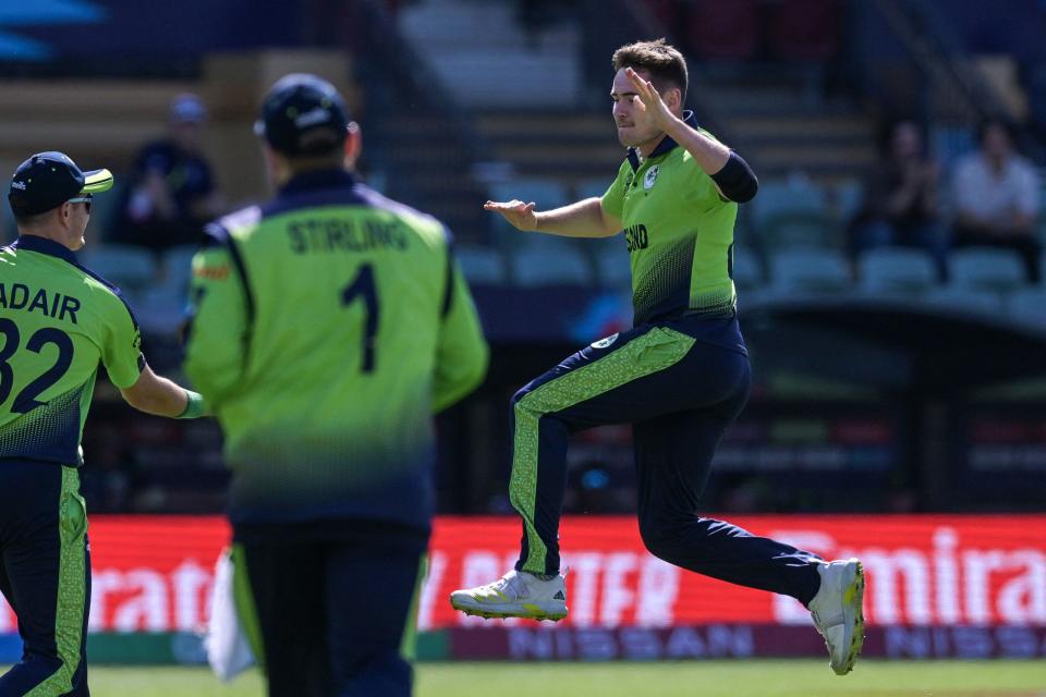 Ireland's Joshua Little (R) celebrates as he scores a hat trick by bowling out New Zealand's Mitchell Santner during the ICC men's Twenty20 World Cup 2022 cricket match between Ireland and New Zealand at the Adelaide Oval in Adelaide on November 4, 2022.