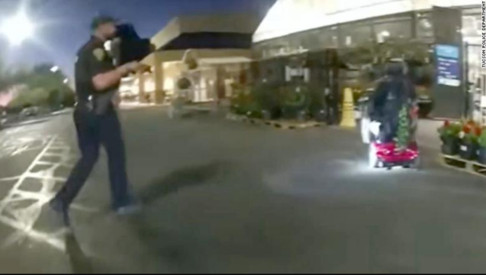 Ryan Remington, an off-duty officer in Arizona, is seen brandishing a firearm on another officer’s body-worn camera before firing nine shots into the back of a 61-year-old man in a wheelchair who allegedly stole a toolbox from the nearby Walmart (Youtube/Tucson Police Department)