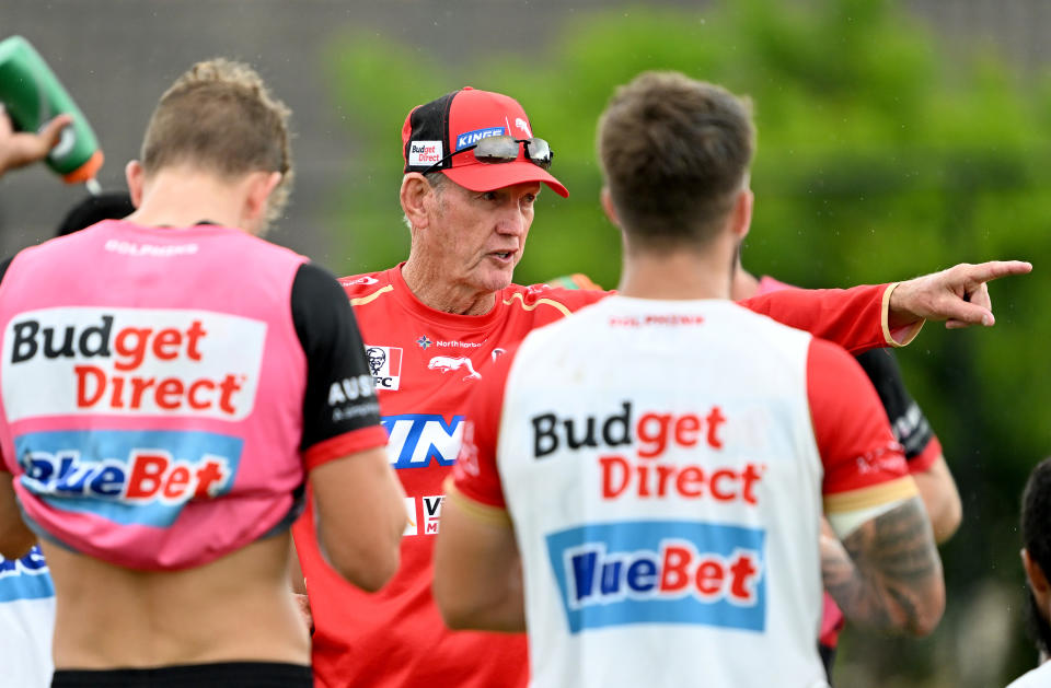 Pictured centre, Dolphins coach Wayne Bennett talks to his players during an NRL training session. 