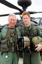 <p>Standing in front of an Apache helicopter with Prince Harry during their visit to the Apache Conversion Course.</p>