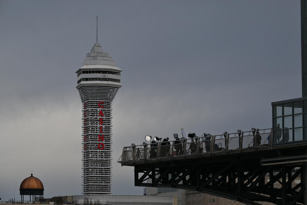 From below, people stand along what appears to be an observation deck. 