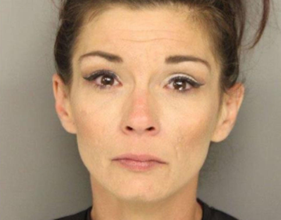 Pictured is a mugshot of Jamie Rathburn. She's accused of entering her son's school and confronting kids about nine years old about bullying her son has been suffering.