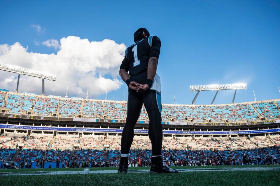Panthers quarterback Cam newton stands on the sidelines and watches the game against the Buccaneers at Bank of America Stadium on Sunday, December 26, 2021 in Charlotte. Newton’s contract end after this season and his future with the Panthers is uncertain.