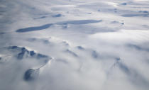 <p>Mountains peek through land ice as seen from NASA’s Operation IceBridge research aircraft in the Antarctic Peninsula region on Nov. 4, 2017, above Antarctica. (Photo: Mario Tama/Getty Images) </p>