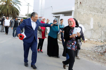 Simon Salama, a Tunisian Jew and 52-year old candidate from the Islamist Ennahda Party in the municipal elections, distributes leaflets in Monastir, Tunisia May 3, 2018. Picture taken May 3, 2018. REUTERS/Zoubeir Souissi