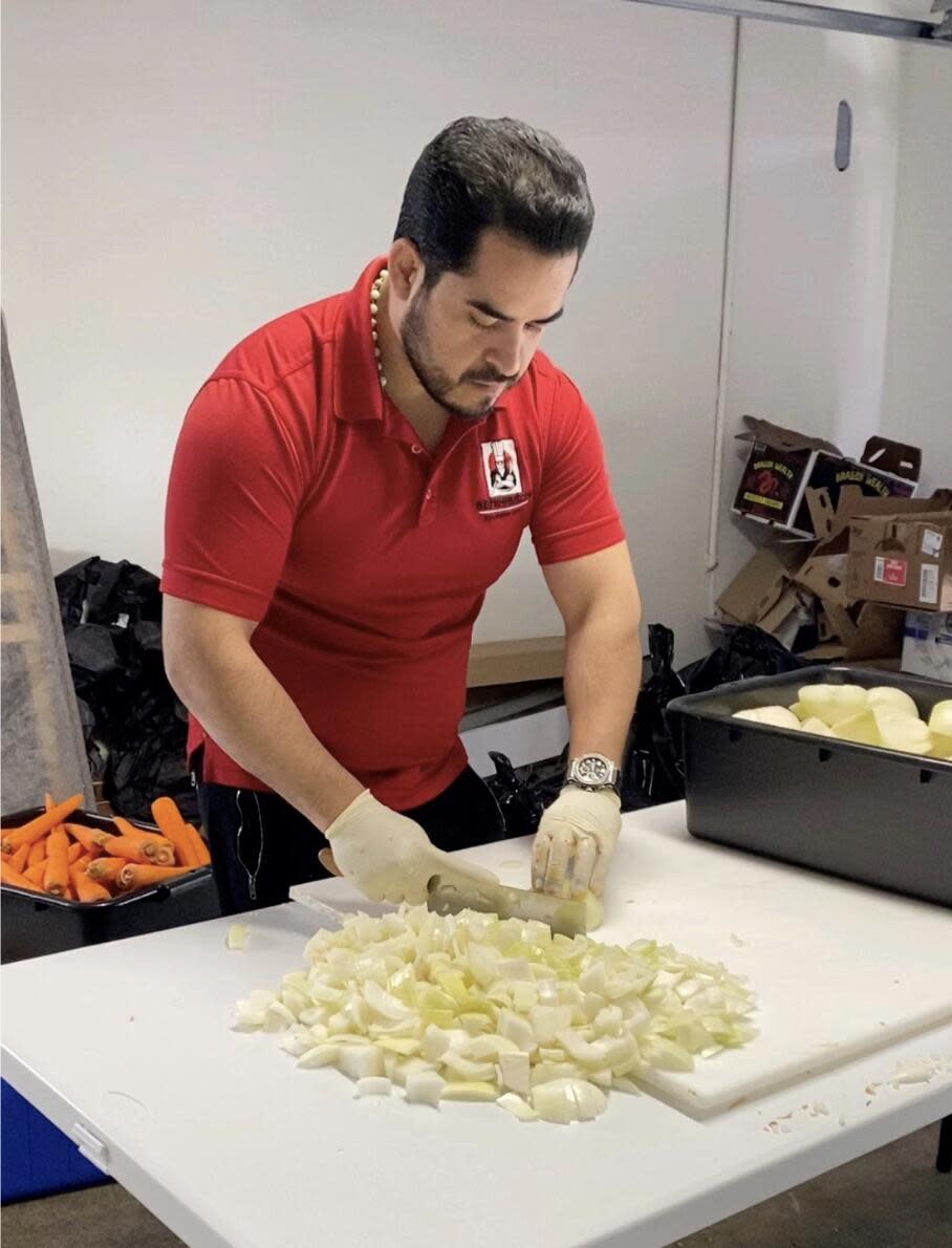 A man cuts vegetables.