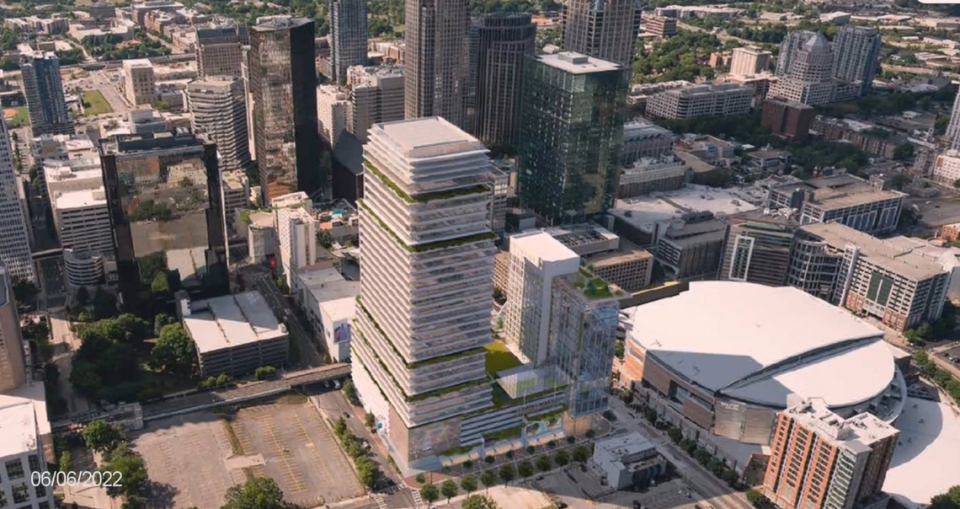 A high-rise building that would contain a practice facility for the Charlotte Hornets stands next to the Spectrum Center in this rendering presented to city officials on Monday.