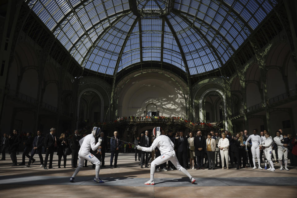 French President Emmanuel Macron attends a demonstration by the French fencing team as he visits the Grand Palais ahead of the Paris 2024 Olympic Games in Paris, Monday, April15, 2024. The Grand Palais will host the Fencing and Taekwondo competitions during the Paris 2024 Olympic Games. (Yoan Valat, Pool via AP)