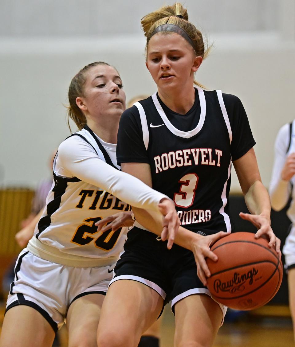 Roosevelt's Katie Keller protects the ball from Cuyahoga Falls' Trista Lee during the first half of their game Wednesday night at Cuyahoga Falls High School.
