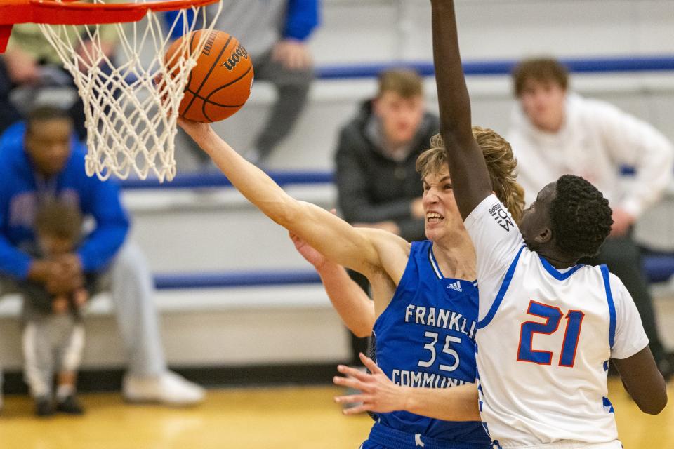 Franklin Community High School junior Kolt Nelson (35) shoots while being defended by Whiteland High School senior Akol Akol (21) during the second half of an IHSAA basketball game, Tuesday, Jan. 9, 2024, at Whiteland High School. Whiteland High School won, 67-64.