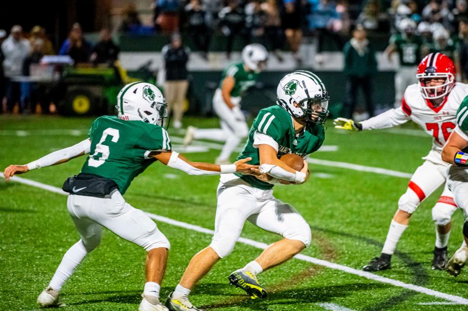 Dartmouth's Nikko Morris hands the ball off to Ray Gramlich.