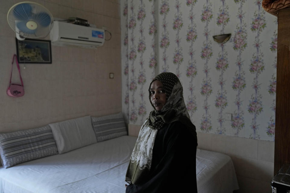 Sudanese woman Rawda Yousif, who has been in Indonesia for eight years, stands for a photograph in her room at Hotel Kolekta, turned into a shelter for refugees, in Batam, an island in northwestern Indonesia, Thursday, May 16, 2024. The former tourist hotel was converted in 2015 into a temporary shelter that today houses 228 refugees from conflict-torn nations including Afghanistan, Somalia, Sudan and elsewhere. (AP Photo/Dita Alangkara)