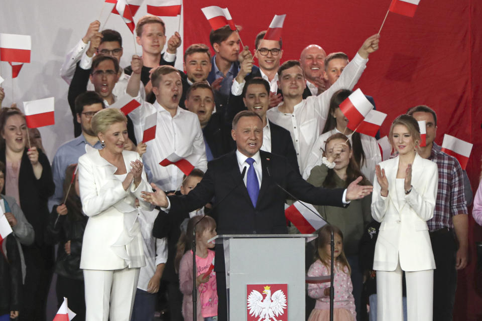 Incumbent President Andrzej Duda, center, gestures next to his wife Agata Kornhauser-Duda and daughter Kinga, right while speaking to supporters in Pultusk, Poland, Sunday, July 12, 2020. Conservative Duda ran against liberal Warsaw Mayor Rafal Trzaskowski in a razor-blade-close presidential election runoff and exit poll shows election is too close to call. (AP Photo/Czarek Sokolowski)