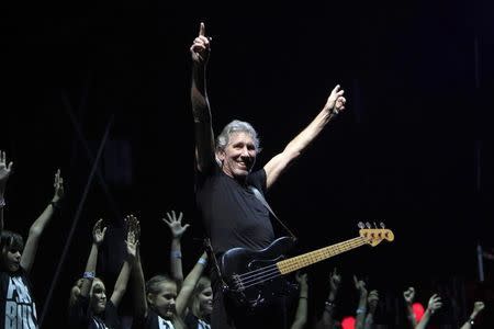 Former Pink Floyd co-founder and bass guitarist Roger Waters performs with a Romanian children choir during "The Wall" tour live concert in Bucharest August 28, 2013. REUTERS/Radu Sigheti