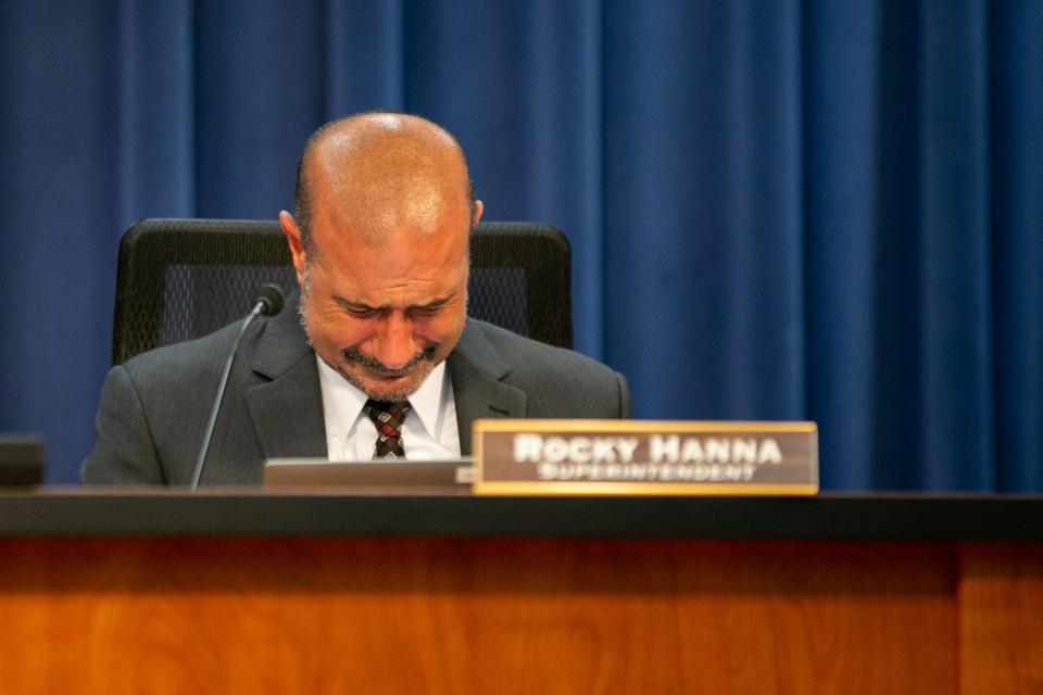 Leon County Schools Superintendent Rocky Hanna bows his head as he cries after Sarah Sprayberry presents him with a basket filled with more than 300 letters, cards and emails that were compiled to by parents, educators and students to show their support of Hanna during a LCS School Board meeting Tuesday, May 9, 2023. 