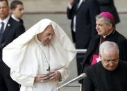 A gust of wind blows Pope Francis' mantle during a meeting with the people affected by the earthquake in front cathedral in Mirandola , Italy, April 2, 2017. REUTERS/Alessandro Garofalo