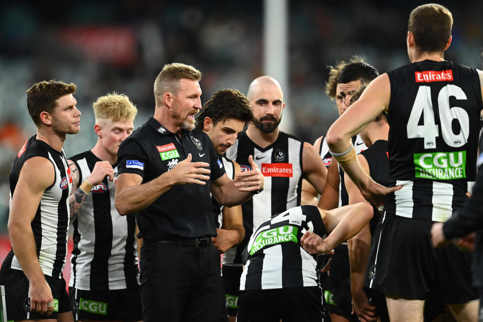 Magpies head coach Nathan Buckley talks to his players during the round four AFL match between the Collingwood Magpies and the Greater Western Sydney Giants at Melbourne Cricket Ground on April 10, 2021 in Melbourne, Australia.