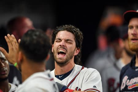 Sep 20, 2018; Atlanta, GA, USA; Atlanta Braves shortstop Dansby Swanson (7) reacts in the dugout after scoring a run against the Philadelphia Phillies during the eighth inning at SunTrust Park. Mandatory Credit: Dale Zanine-USA TODAY Sports