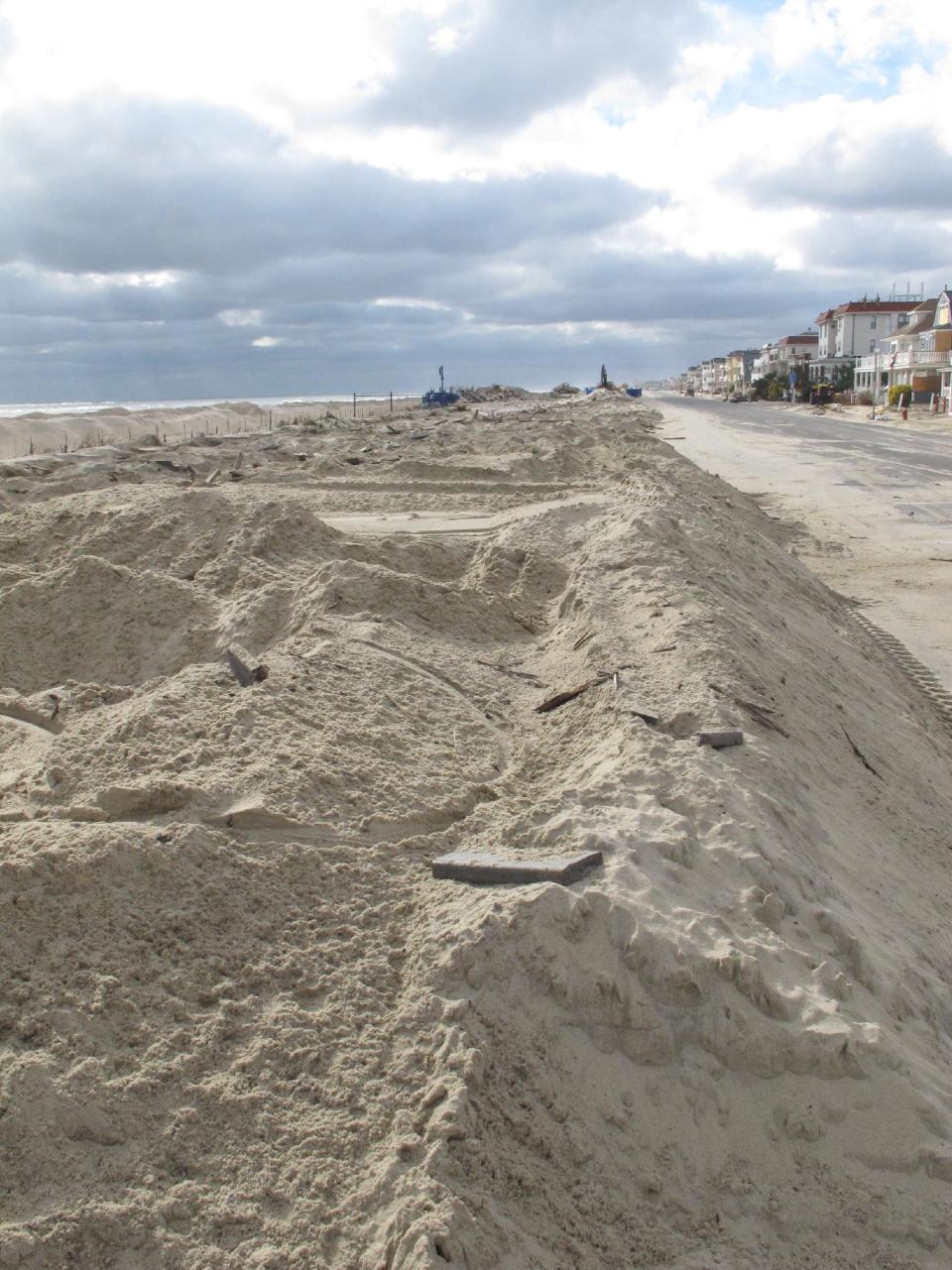 Piles of sand are all that remain where the Belmar N.J. boardwalk used to stand, in a Nov. 15, 2012 photo. Superstorm Sandy took a bite out of the Jersey shore, washing away millions of tons of sand and slimming down beaches along the state’s 127-mile coastline. (AP Photo/Wayne Parry)