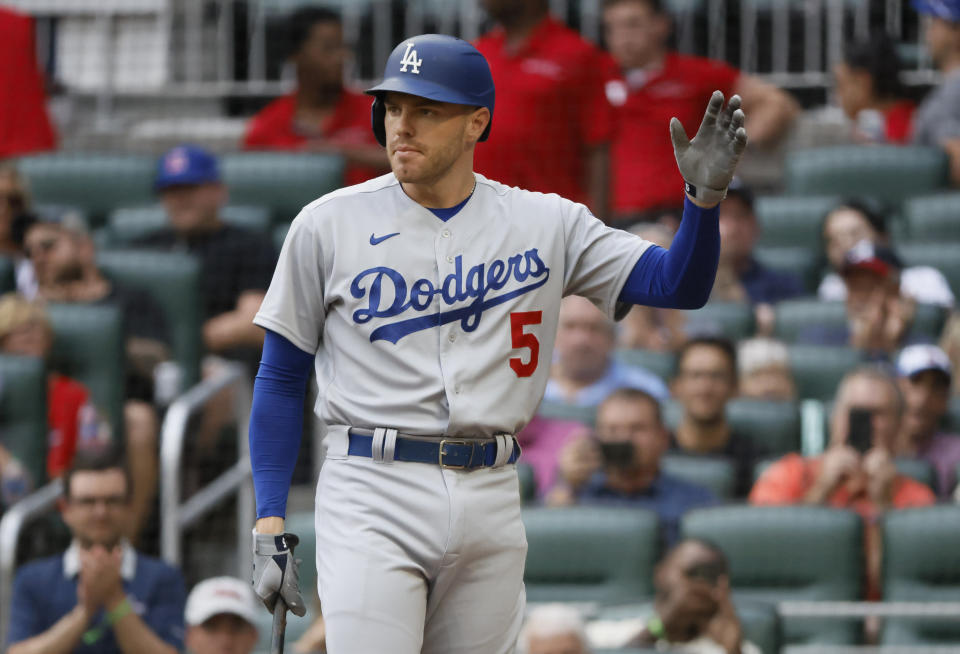 Los Angeles Dodgers' Freddie Freeman reacts to a standing ovation as he takes his first at-bat during the first inning of a baseball game against the Atlanta Braves, Sunday, June 26, 2022, in Atlanta. (AP Photo/Bob Andres)