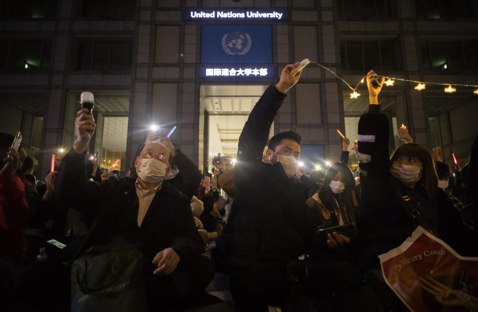 People sing a song written in protest to the Myanmar military's coup during a demonstration organized by a group called "WeLoveMyanmar" in front of the United Nations University in Tokyo on Thursday, Feb. 11, 2021. (AP Photo/Hiro Komae)