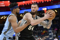 San Antonio Spurs forward Sandro Mamukelashvili (54) handles the ball against Memphis Grizzlies guard Jordan Goodwin in the first half of an NBA basketball game Tuesday, April 9, 2024, in Memphis, Tenn. (AP Photo/Brandon Dill)