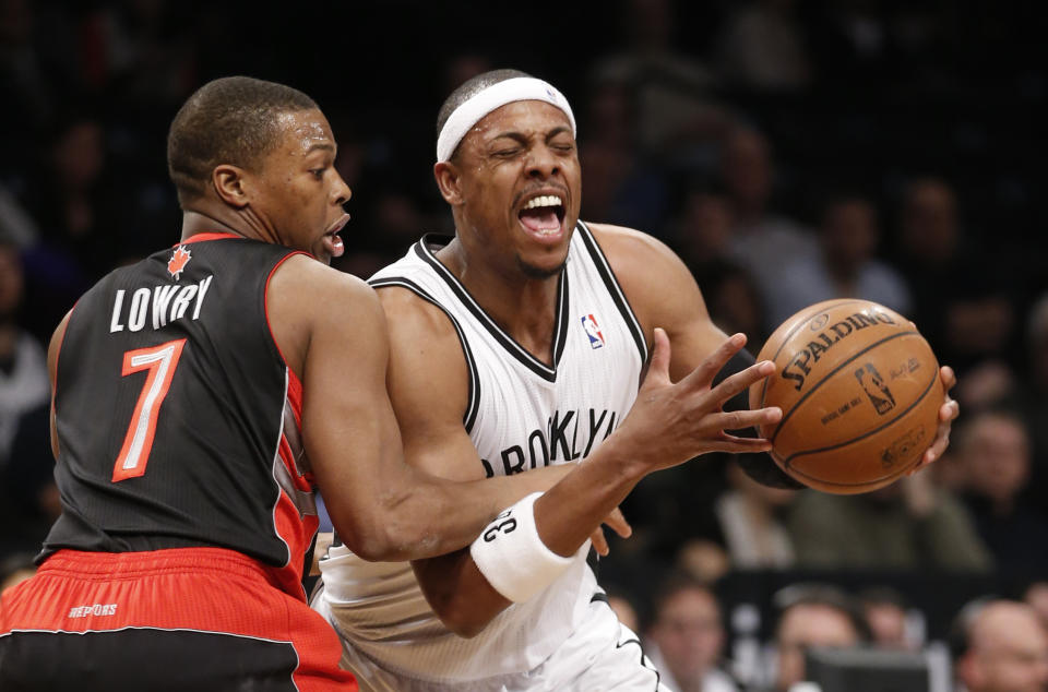 Toronto Raptors guard Kyle Lowry (7) gets tangled up with Brooklyn Nets forward Paul Pierce, right, in the first half of an NBA basketball game, Monday, Jan. 27, 2014, in New York. (AP Photo/Kathy Willens)