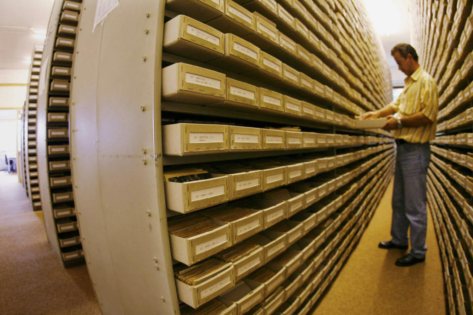 An employee of the International Tracing Service (ITS), an arm of the International Committee of the Red Cross based in Bad Arolsen, works in a part of the ITS files department on July 28, 2006. (MARTIN OESER/AFP/GettyImages)