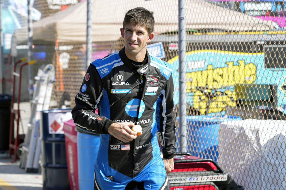 Ricky Taylor walks pit road during auto race testing for the upcoming Rolex 24 hour race at Daytona International Speedway, Friday, Jan. 20, 2023, in Daytona Beach, Fla. (AP Photo/John Raoux)