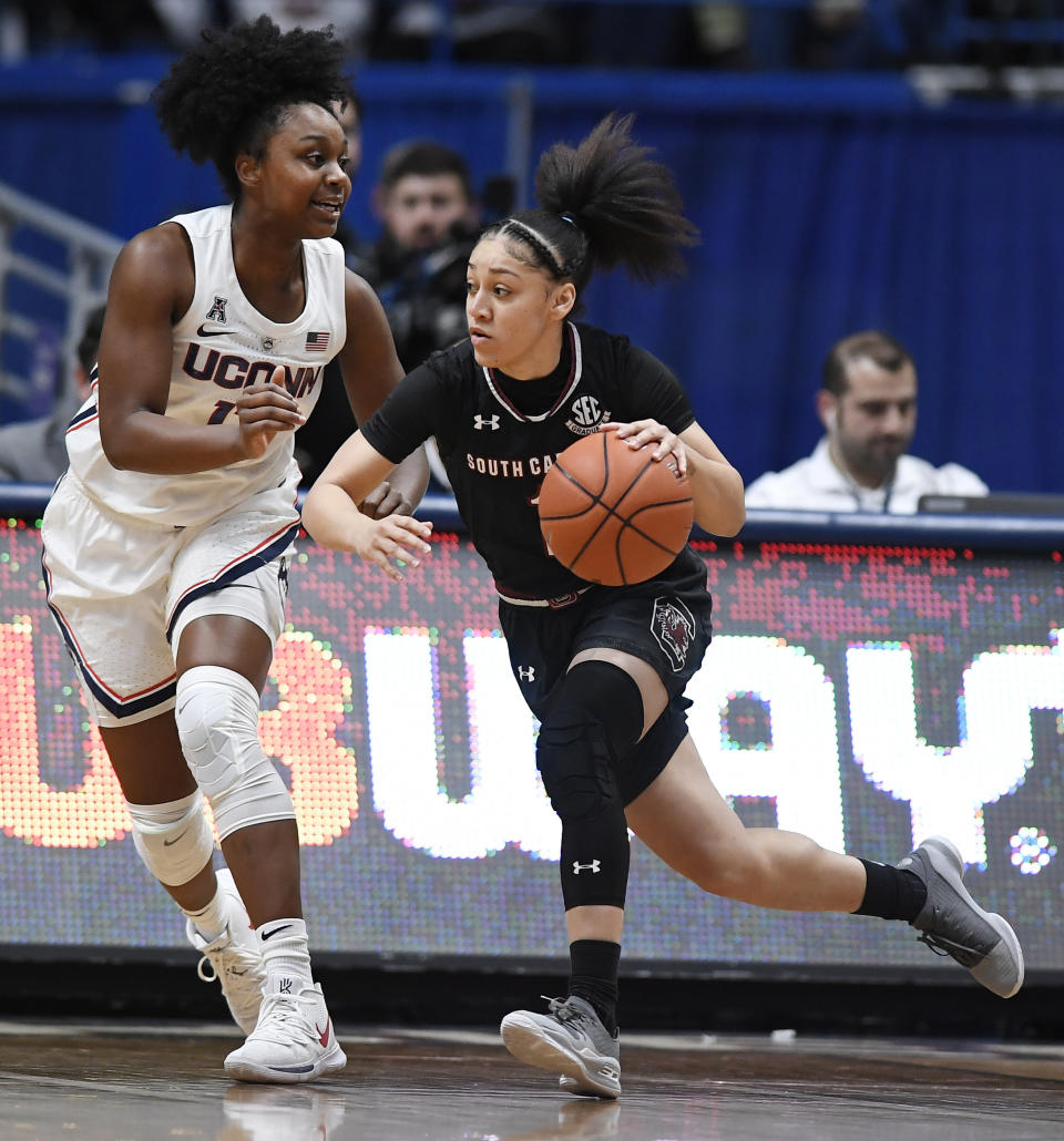 South Carolina's Bianca Cuevas-Moore, right, dribbles as Connecticut's Christyn Williams defends, during the first half of an NCAA college basketball game, Monday, Feb. 11, 2019, in Hartford, Conn. (AP Photo/Jessica Hill)