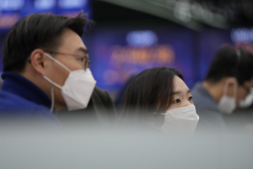 Currency traders watch their computer monitors near the screen showing the Korea Composite Stock Price Index (KOSPI) at a foreign exchange dealing room in Seoul, South Korea, Friday, Nov. 12, 2021. Shares were mostly higher in Asia on Friday after Wall Street benchmarks managed to close mostly higher. (AP Photo/Lee Jin-man)