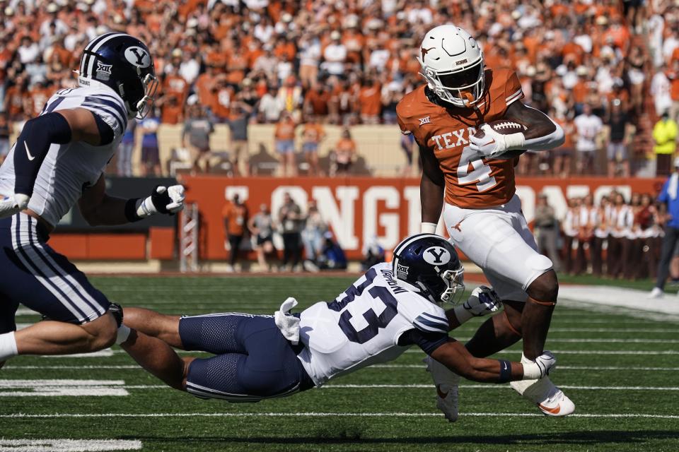 Texas running back CJ Baxter (4) is hit by BYU safety Raider Damuni (33) on a run during the first half of an NCAA college football game in Austin, Texas, Saturday, Oct. 28, 2023. | Eric Gay, Associated Press