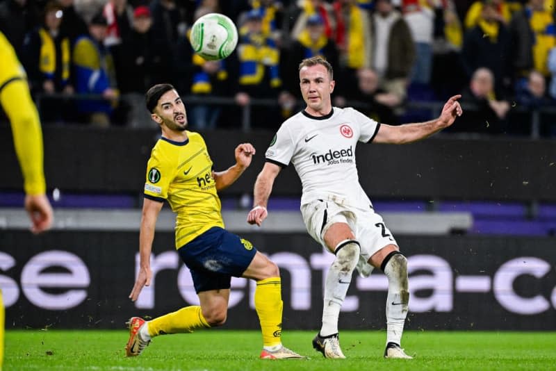 Union's Mohamed Amoura (L) and Frankfurt's Mario Goetze battle for the ball during the UEFA Europa Conference League intermediate round first leg soccer match between Royale Union Saint-Gilloise and Eintracht Frankfurt at Lotto Park. Laurie Dieffembacq/Belga/dpa