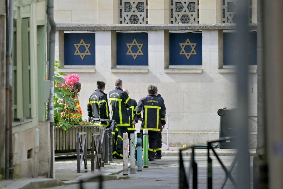 Fire brigade members stand by a synagogue in the Normandy city of Rouen where French police have killed earlier an armed man who was trying to set fire to the building (AFP via Getty Images)