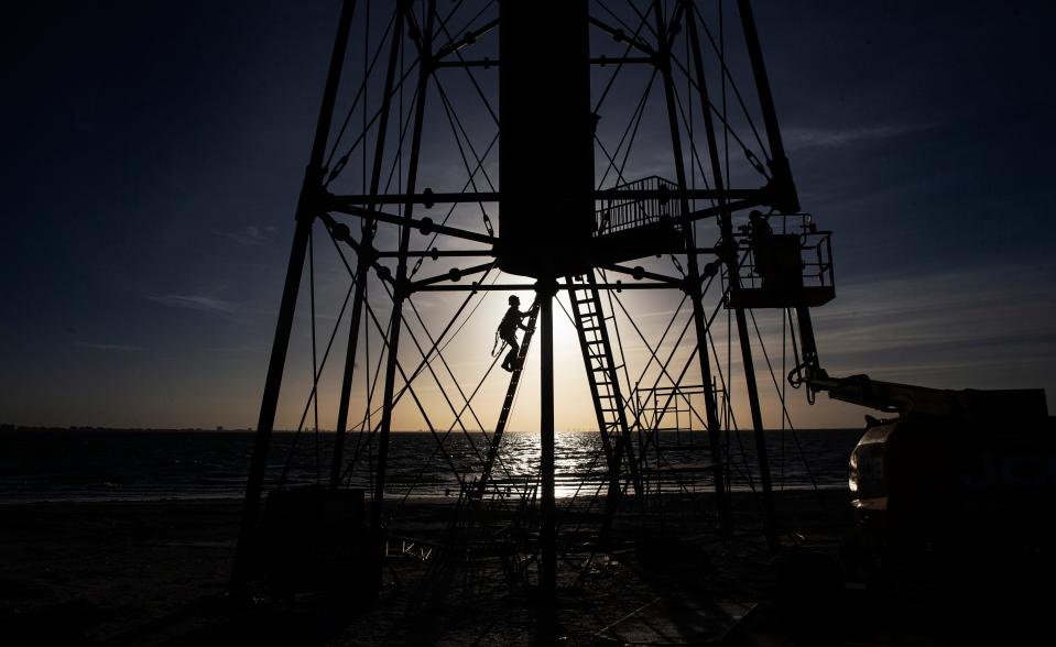 A member of the construction crew works on the Sanibel Lighthouse on Tuesday, Jan. 23, 2024. A missing leg lost in Hurricane Ian was installed on the popular landmark.