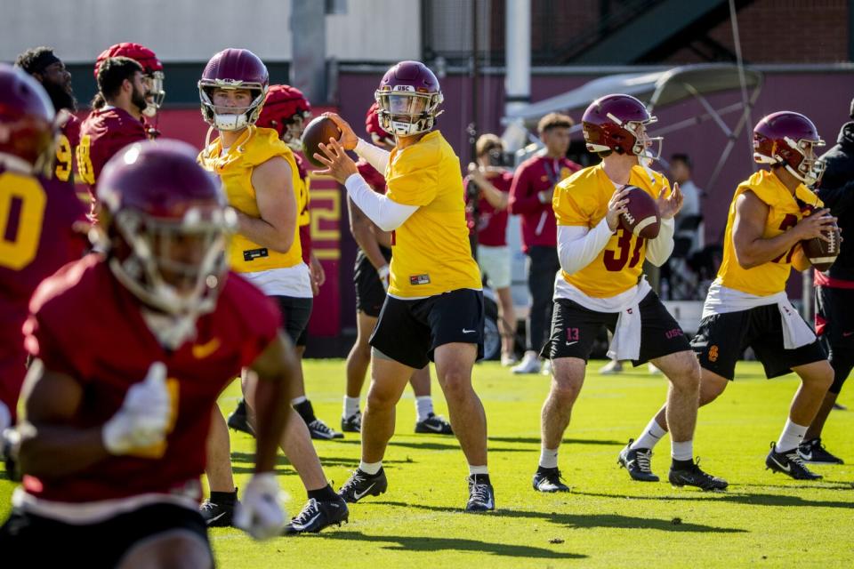 USC transfer quarterback Caleb Williams runs through passing drills with other quarterbacks.