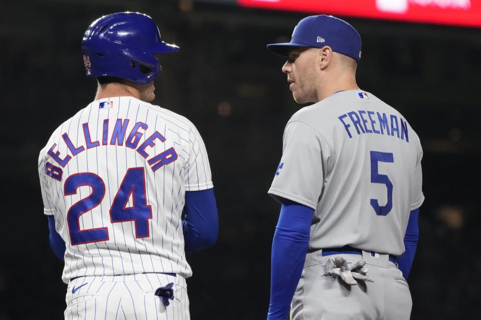 Chicago Cubs' Cody Bellinger, left, talks with Los Angeles Dodgers first baseman Freddie Freeman during the third inning of a baseball game in Chicago, Thursday, April 20, 2023. (AP Photo/Nam Y. Huh)