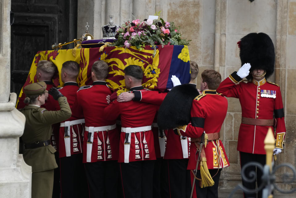 The coffin of Queen Elizabeth II is carried into Westminster Abbey for her funeral in central London, Monday, Sept. 19, 2022. The Queen, who died aged 96 on Sept. 8, will be buried at Windsor alongside her late husband, Prince Philip, who died last year. (AP Photo/Bernat Armangue, Pool)