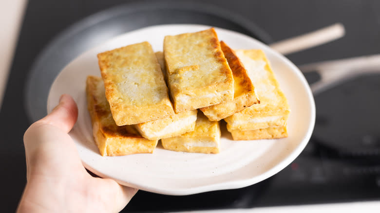 golden tofu stacked on plate