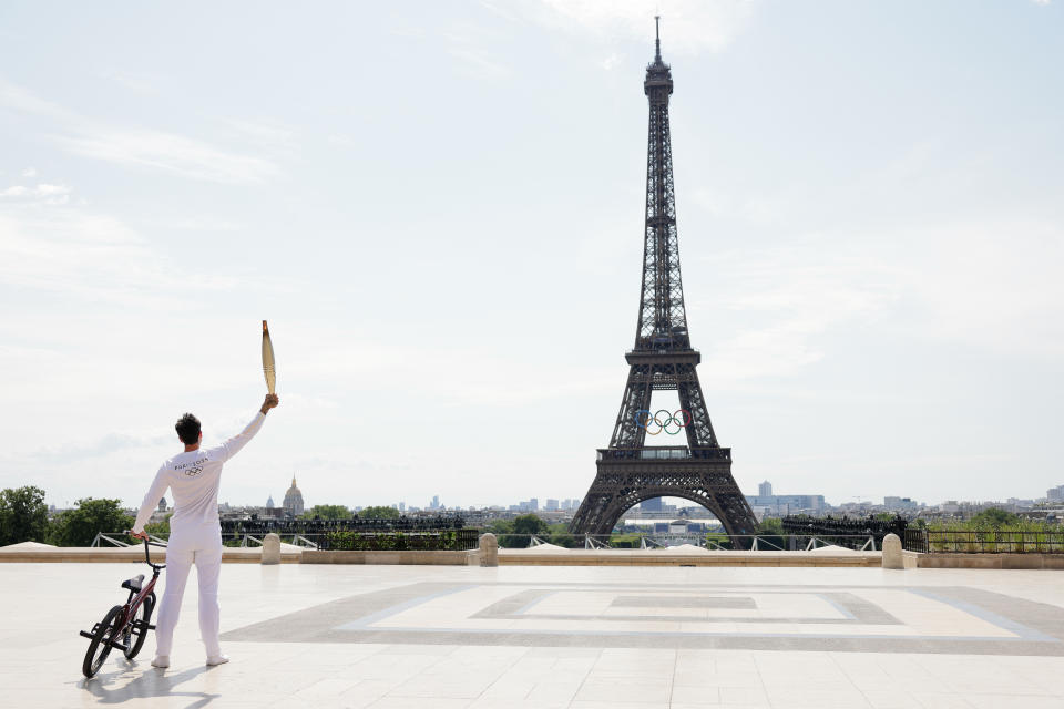 Torch bearer Matthias Dandois, the French cyclist, near the Eiffel Tower during Day 2 of Torch Relay