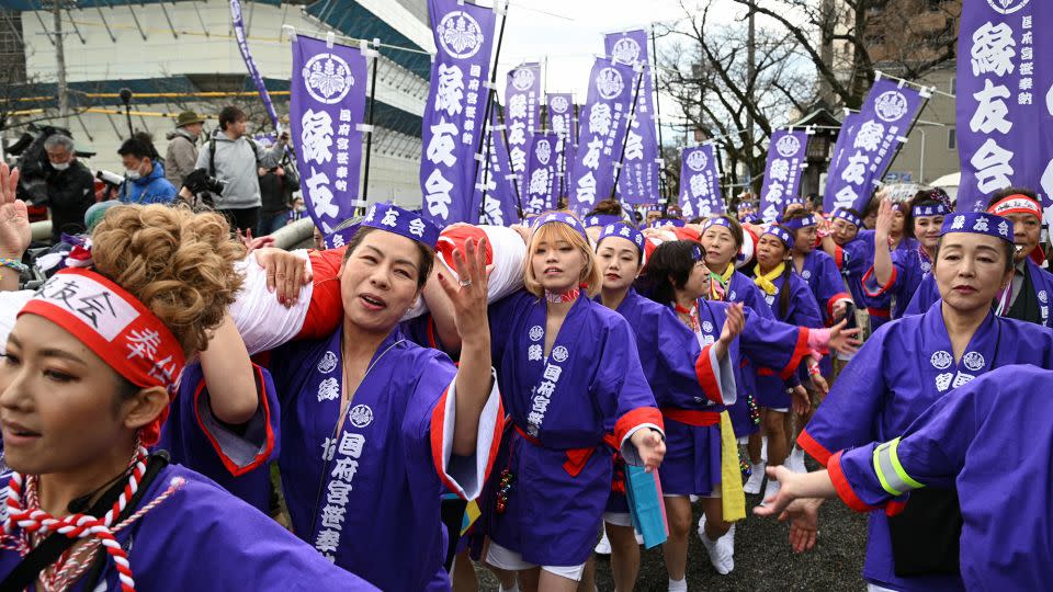 Women — donning happi, a traditional festive coat — are responsible for carrying a bamboo offering during the naked festival at Konomiya Shrine on February 22, 2024. - Chris Gallagher/Reuters