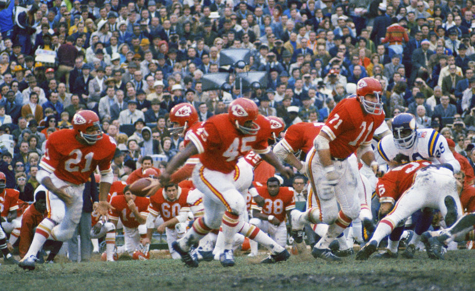 FILE - Kansas City Chiefs quarterback Len Dawson prepares to hand off to running back Mike Garrett (21) as running back Robert Holmes (45) and guard Ed Budde (71) lead the play against the Minnesota Vikings during the football Super Bowl in New Orleans on Jan. 11, 1970. Budde, who spent 14 years playing along the offensive line of the Chiefs and helped the franchise win its first Super Bowl in 1970, died Tuesday, Dec. 19, 2023. He was 83. The family announced his death through a statement issued by the Chiefs. No cause of death was provided. (AP Photo, File)