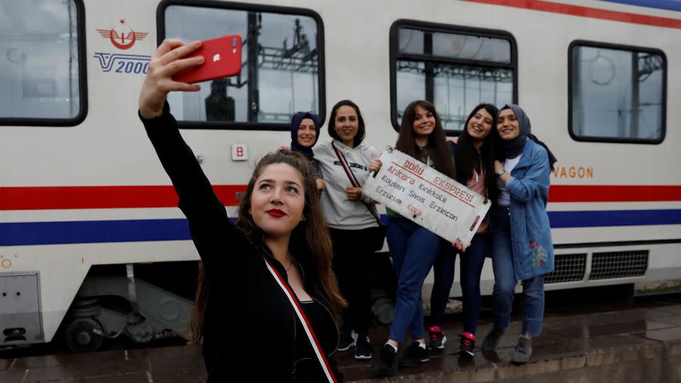 A traveler poses for a selfie with her friends before the Eastern Express departs Ankara. - Umit Bektas/Reuters